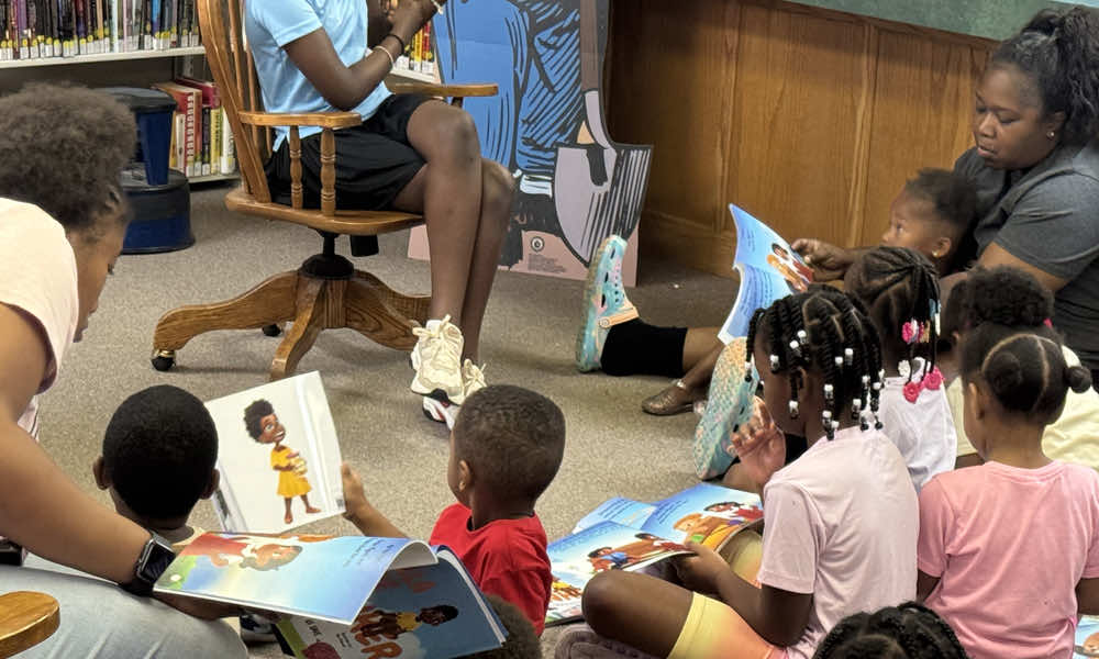 Group of kids reading a book